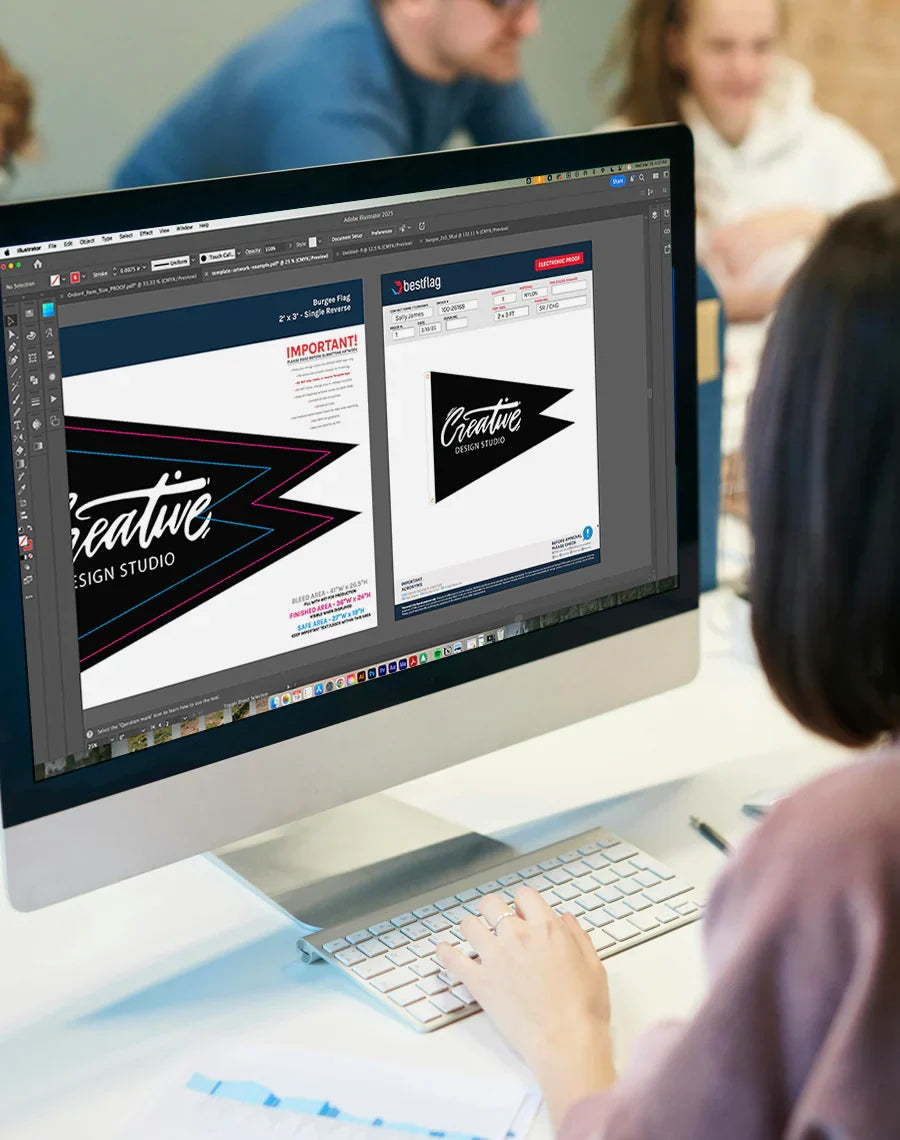 Person working on a computer with design software open, showing text and graphics.