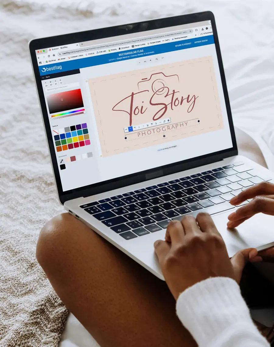 Person using a laptop with a design software open on the screen, displaying a logo for 'Toi Story Photography'.