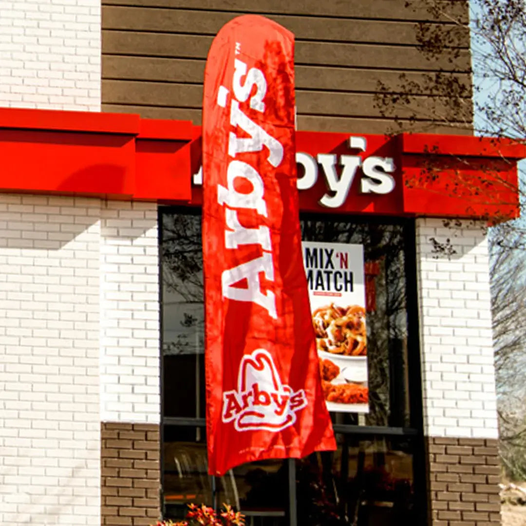 Red Arby's flag outside a restaurant building