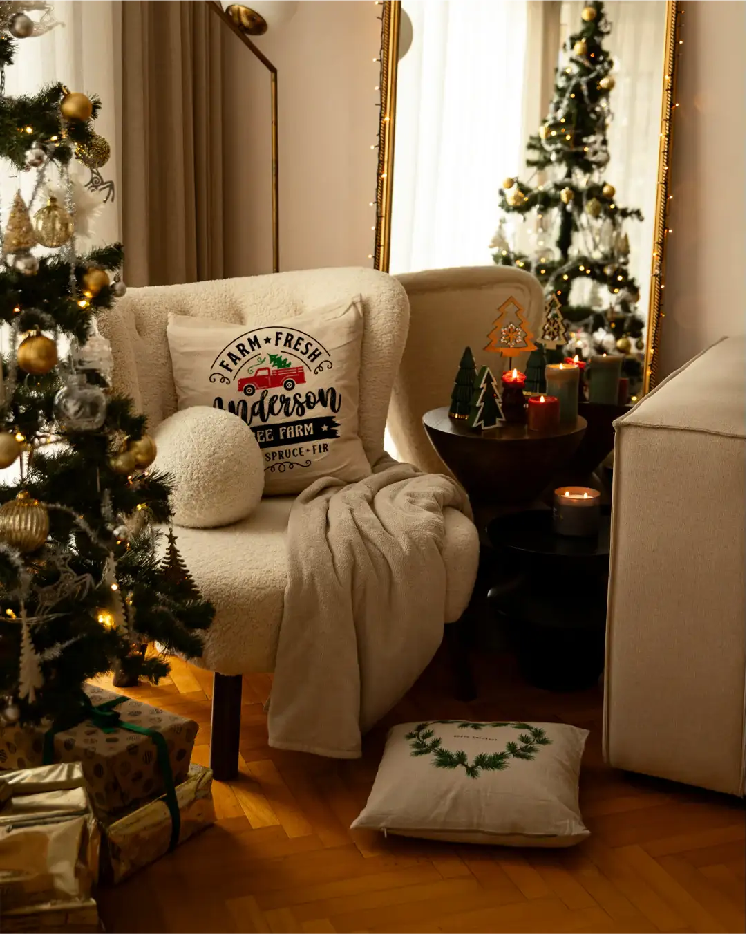 Cozy living room with Christmas decorations, including a tree, pillows, and candles.